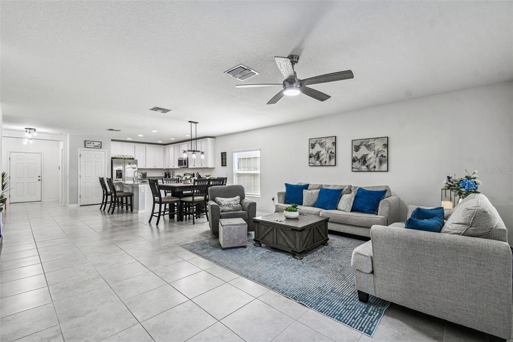 12907 Conquistador Loop Spring Hill, FL 34610 - Photo 27 of 74 a living room with furniture and kitchen view