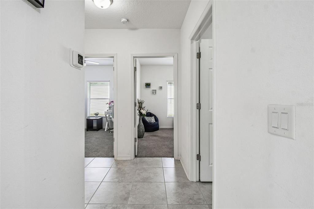 12907 Conquistador Loop Spring Hill, FL 34610 - Photo 33 of 74 a view of a hallway with a livingroom and a chair
