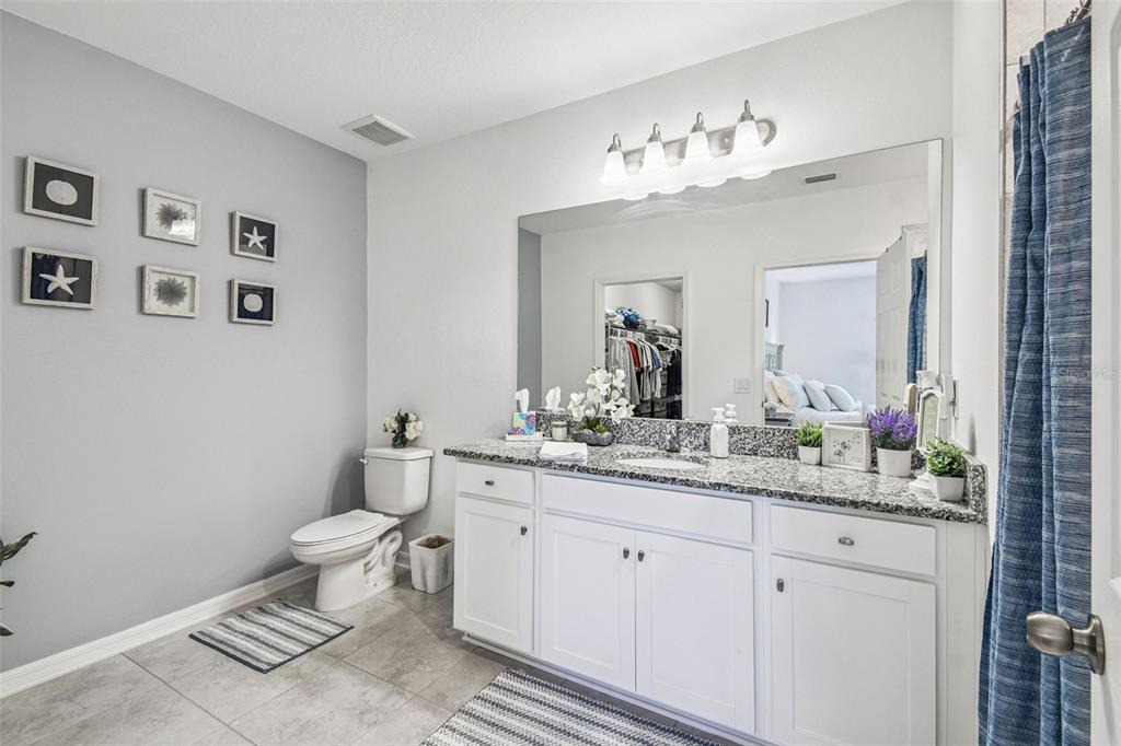 12907 Conquistador Loop Spring Hill, FL 34610 - Photo 47 of 74 a bathroom with a toilet sink and mirror