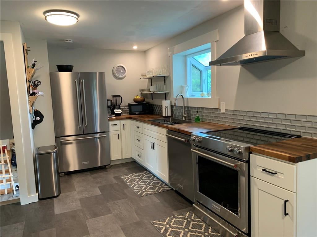 200 Fezell Road Freedom, PA 15042 - Photo 9 of 22 Kitchen after the renovation! NO expense spared. Appliances are high end Kitchenaid. Butcher block has been permanently treated. Flooring is water and pet proof. Cabinets are Maple with soft close cabinets and drawers.