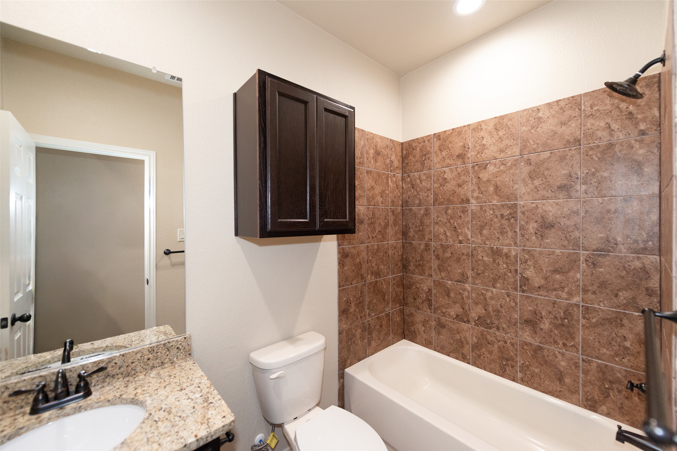 245 Joanne Loop, Unit B Buda, TX 78610 - Photo 16 of 33 Secondary full bathroom, granite counters, fully tiled shower, extra cabinet, recessed lighting