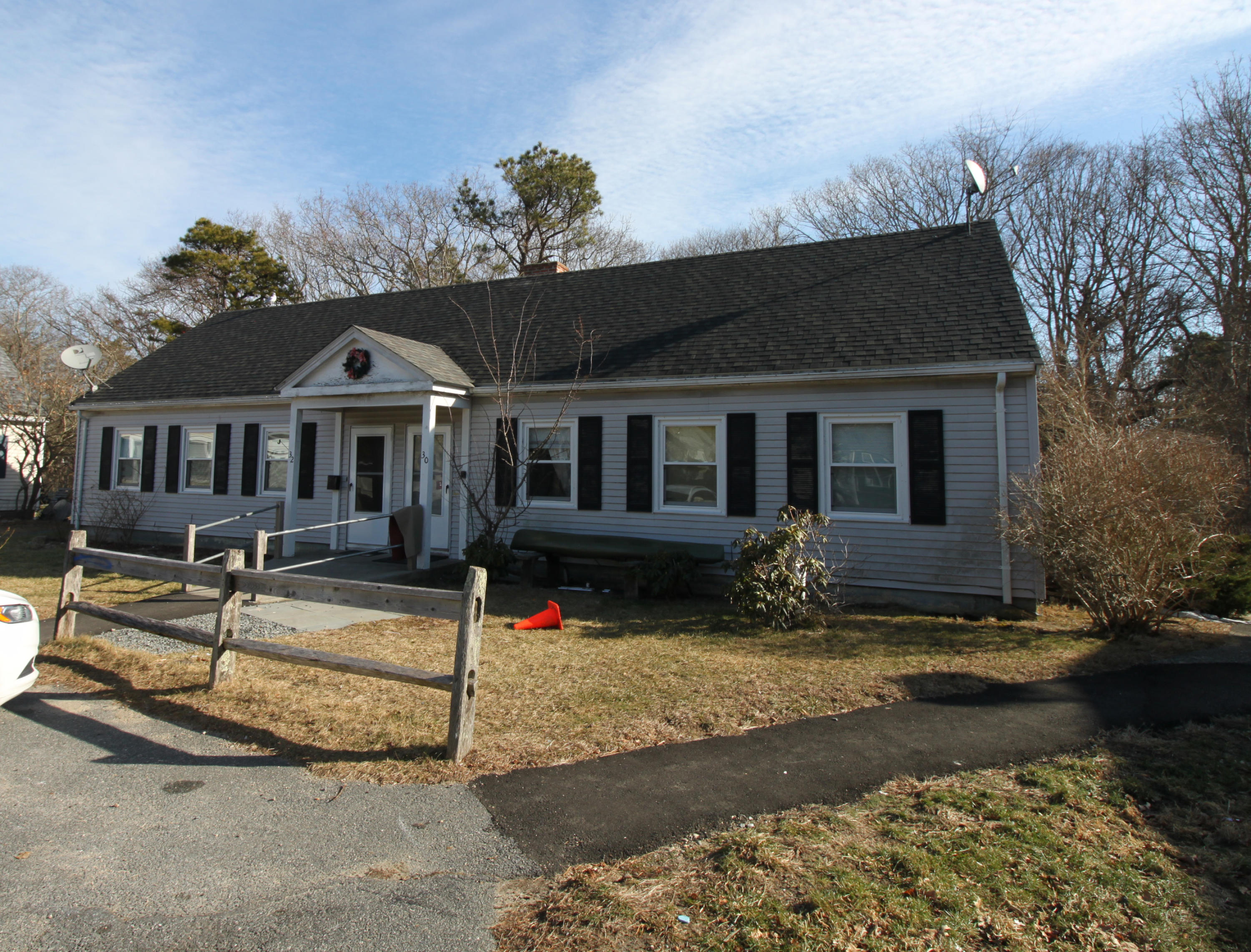 30 Fresh Holes Road, Unit 30 & 32 Hyannis, MA 02601 - Photo 1 of 27 a front view of a house with garden