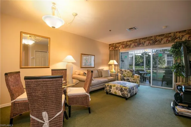 a bedroom with furniture and a large window