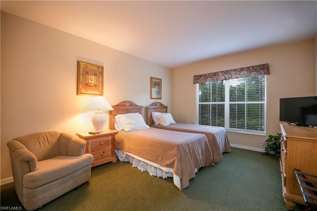 7870 Mahogany Run Lane, Unit 1713 Naples, FL 34113 - Photo 5 of 15 a bedroom with a bed and a couch