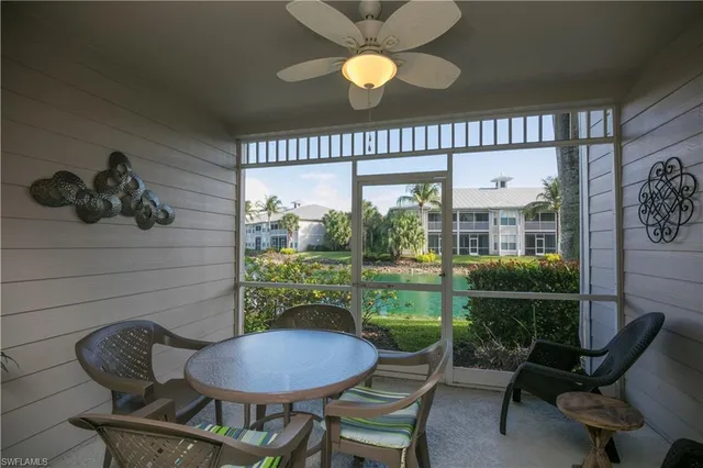 a view of a porch with furniture and a floor to ceiling window
