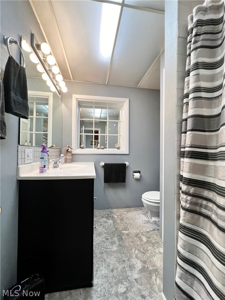 4663 East Harbor Road Port Clinton, OH 43452 - Photo 25 of 31 Bathroom featuring toilet, tile floors, and vanity