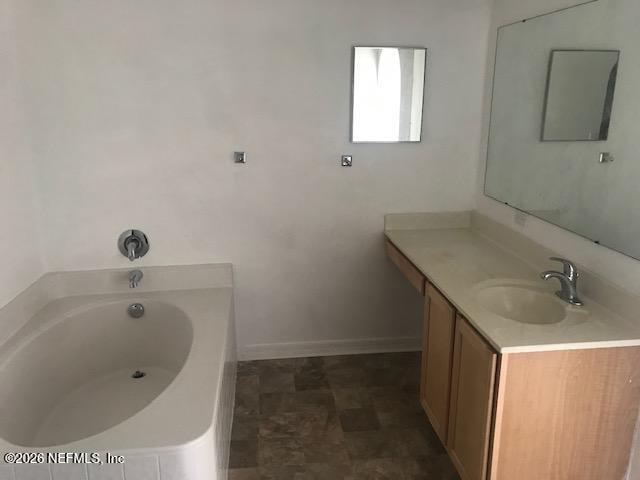 87045 Kipling Drive Yulee, FL 32097 - Photo 6 of 18 a bathroom with a tub sink and mirror