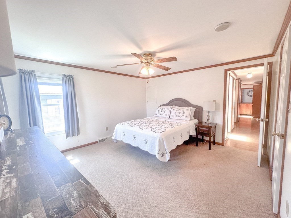 59 Castle Road Attleboro, MA 02703 - Photo 11 of 30 a spacious bedroom with a bed and a chandelier