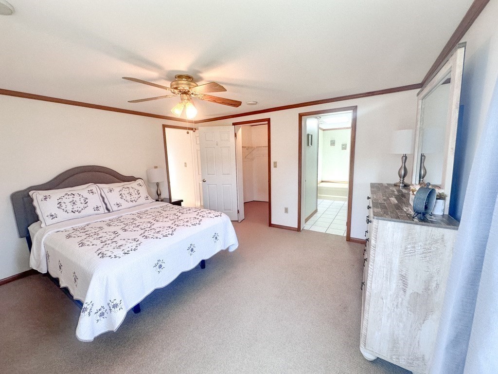 59 Castle Road Attleboro, MA 02703 - Photo 13 of 30 a bedroom with a large bed and a chandelier