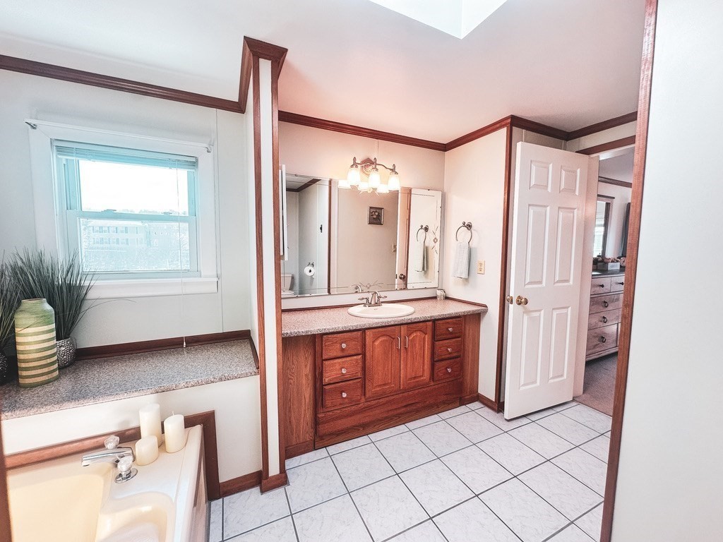 59 Castle Road Attleboro, MA 02703 - Photo 15 of 30 a spacious bathroom with a double vanity sink a mirror and a bathtub