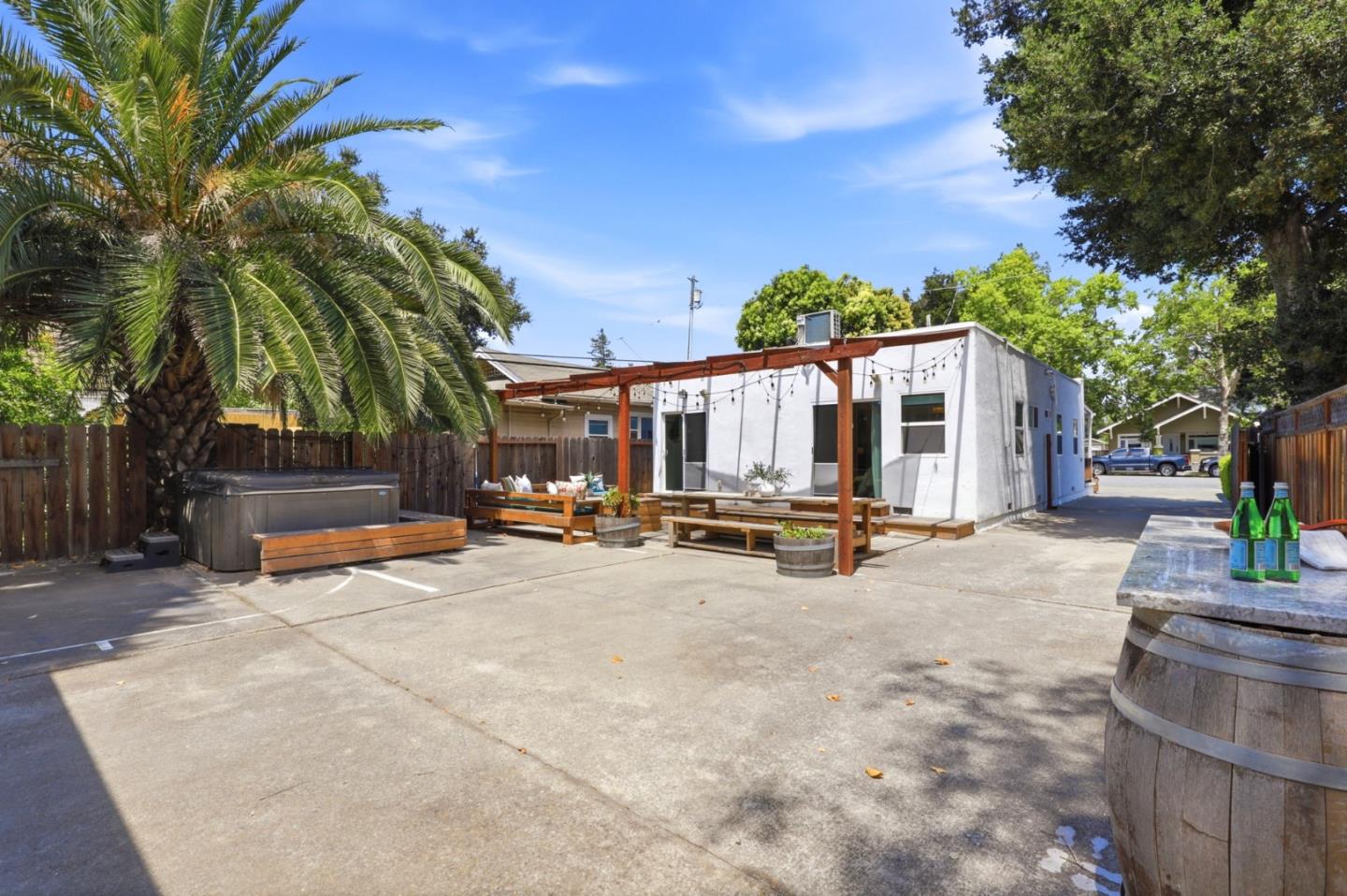 140 Second Street Gilroy, CA 95020 - Photo 30 of 33 a view of a patio with table and chairs under an umbrella with wooden fence