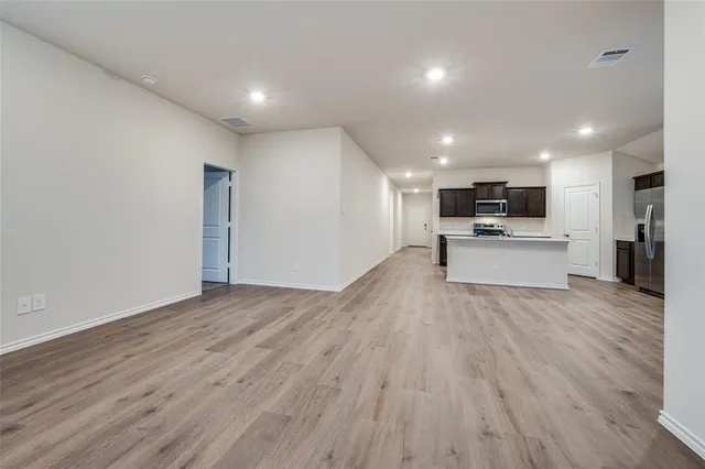 a view of kitchen with wooden floor and electronic appliances