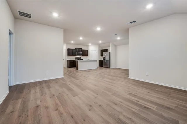 a view of a kitchen with a sink and a refrigerator