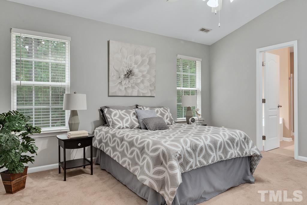 3122 Binghampton Lane Raleigh, NC 27604 - Photo 13 of 28 a bedroom with a large bed and a potted plant