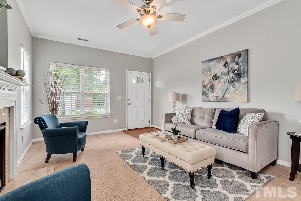 3122 Binghampton Lane Raleigh, NC 27604 - Photo 4 of 28 a living room with furniture a chandelier and a window