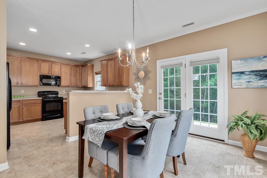3122 Binghampton Lane Raleigh, NC 27604 - Photo 6 of 28 a kitchen with a table chairs refrigerator and microwave