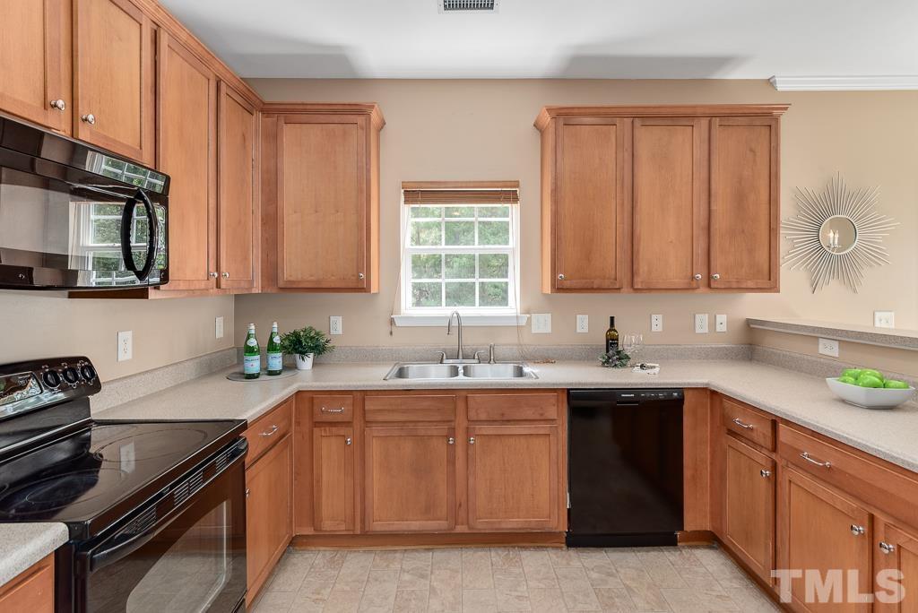 3122 Binghampton Lane Raleigh, NC 27604 - Photo 8 of 28 a kitchen with a sink stove top oven and cabinets