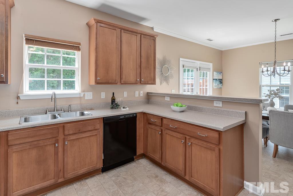 3122 Binghampton Lane Raleigh, NC 27604 - Photo 9 of 28 a kitchen with a sink window and cabinets