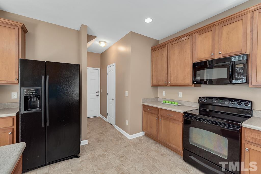 3122 Binghampton Lane Raleigh, NC 27604 - Photo 10 of 28 a kitchen with stainless steel appliances a refrigerator a stove a sink and a microwave