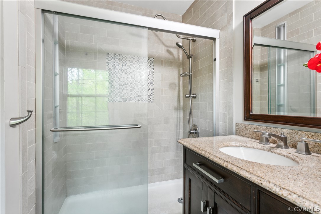 204 Old Cart Road Williamsburg, VA 23188 - Photo 21 of 49 a bathroom with a granite countertop shower sink and mirror