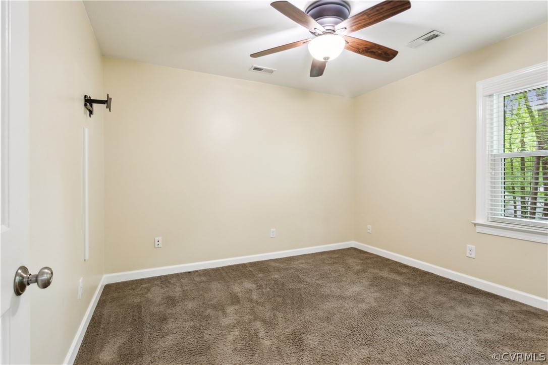 204 Old Cart Road Williamsburg, VA 23188 - Photo 23 of 49 an empty room with windows and fan