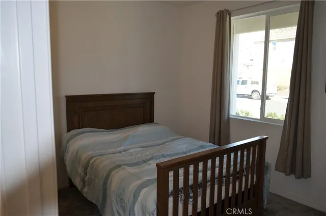 a bedroom with a bed and window