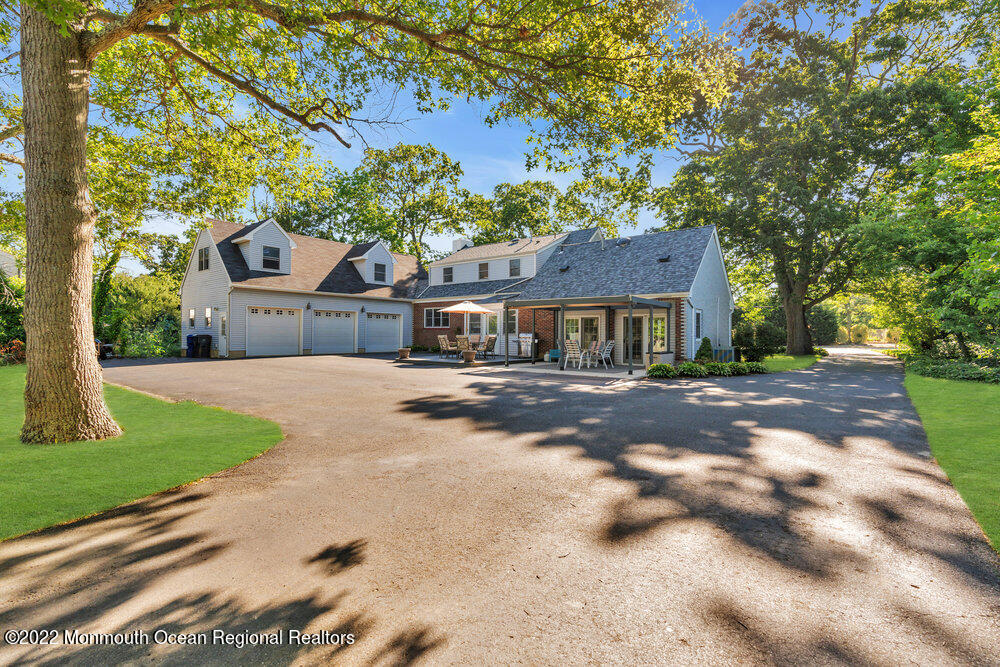 30 Brand Road Toms River, NJ 08753 - Photo 8 of 54 a front view of a house with a yard and garage