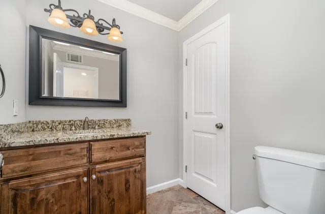 a bathroom with a sink vanity and a mirror