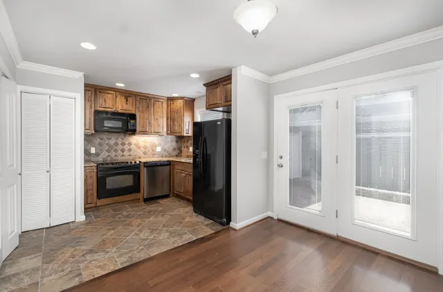 a kitchen with a refrigerator and a stove top oven