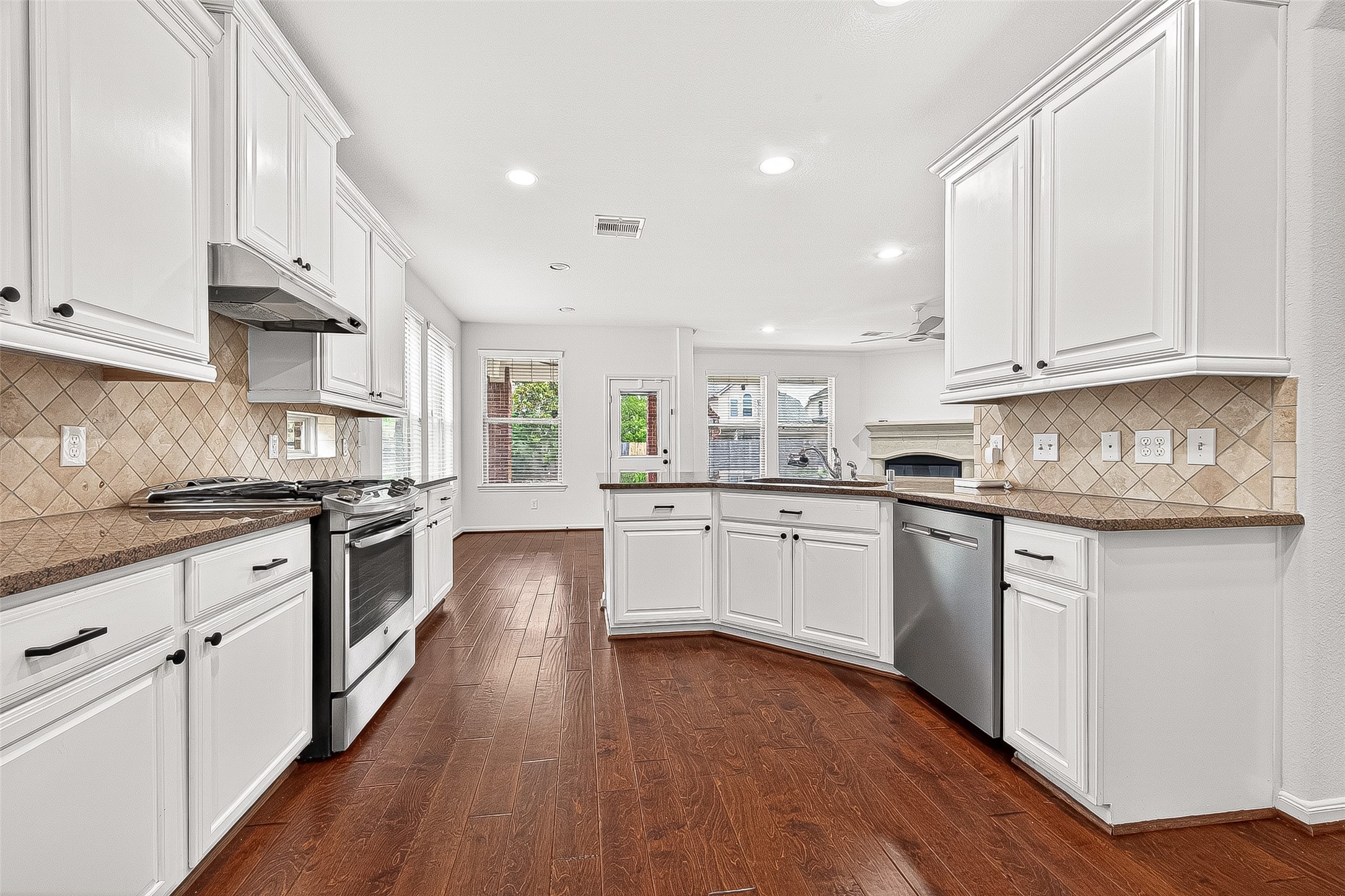 138 South Sawbridge Circle Spring, TX 77389 - Photo 12 of 37 a kitchen with granite countertop white cabinets and white appliances