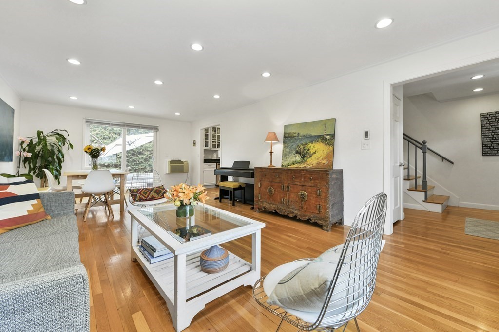 a living room with fireplace furniture and a wooden floor