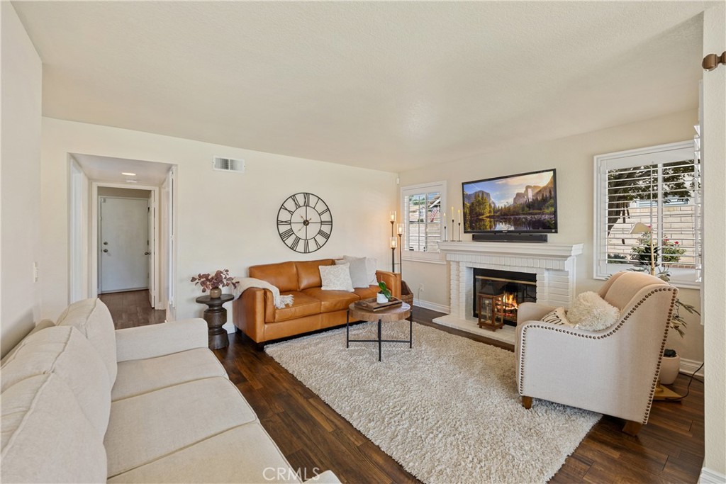 7051 Stanislaus Place Rancho Cucamonga, CA 91701 - Photo 15 of 57 a living room with furniture fireplace and flat screen tv