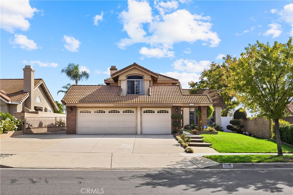 7051 Stanislaus Place Rancho Cucamonga, CA 91701 - Photo 2 of 57 a front view of a house with garden