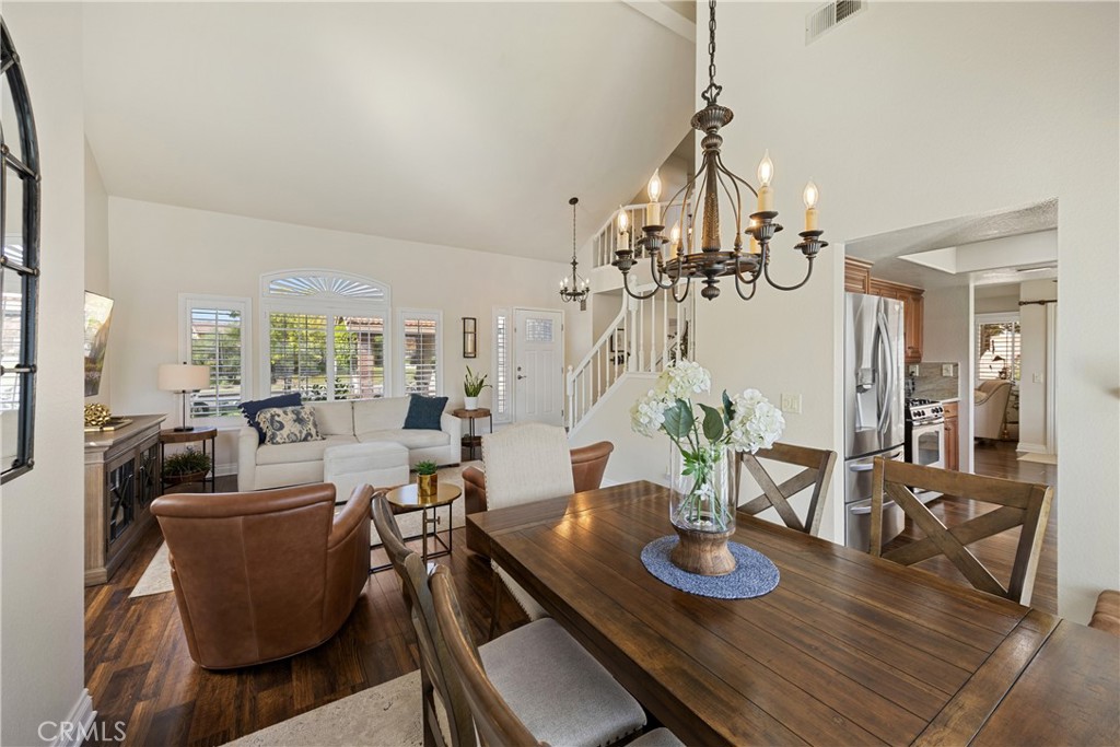 7051 Stanislaus Place Rancho Cucamonga, CA 91701 - Photo 25 of 57 a view of a dining room with furniture wooden floor and chandelier