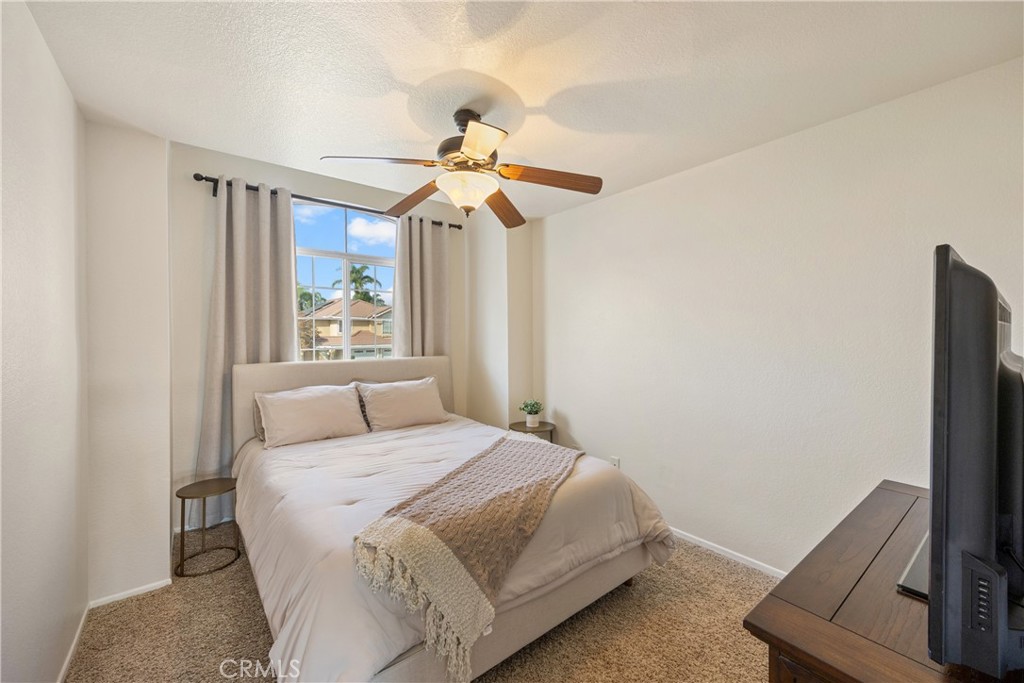 7051 Stanislaus Place Rancho Cucamonga, CA 91701 - Photo 27 of 57 a bedroom with a bed and a chandelier