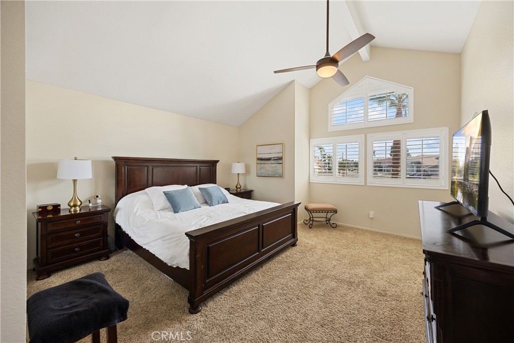 7051 Stanislaus Place Rancho Cucamonga, CA 91701 - Photo 30 of 57 a bedroom with a bed flat screen tv and a large window