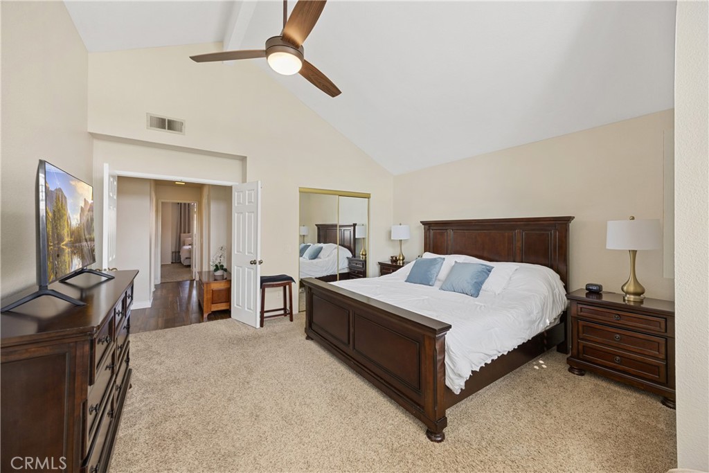 7051 Stanislaus Place Rancho Cucamonga, CA 91701 - Photo 31 of 57 a bedroom with a bed and dresser with mirror