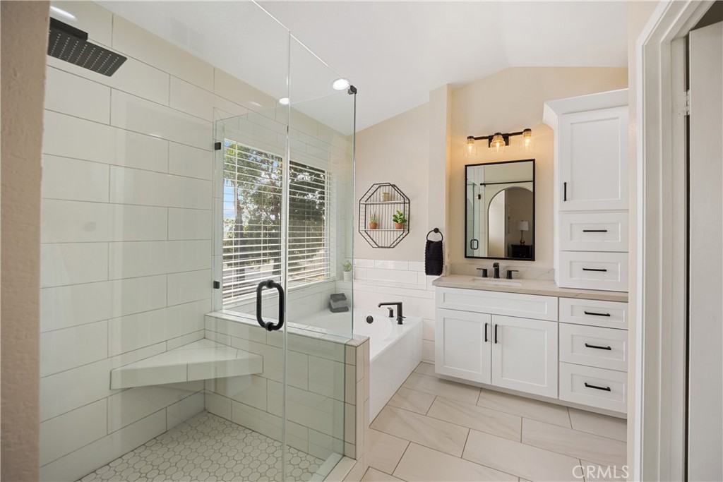 7051 Stanislaus Place Rancho Cucamonga, CA 91701 - Photo 34 of 57 a bathroom with a sink a mirror and a bathtub