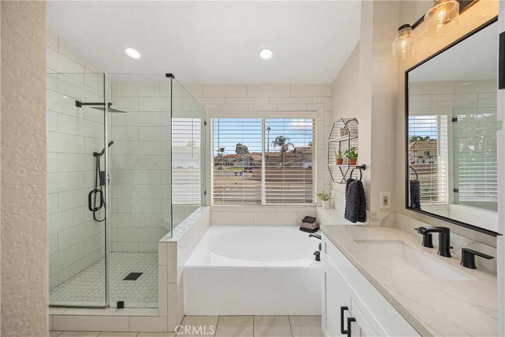 7051 Stanislaus Place Rancho Cucamonga, CA 91701 - Photo 36 of 57 a bathroom with a tub sink and shower