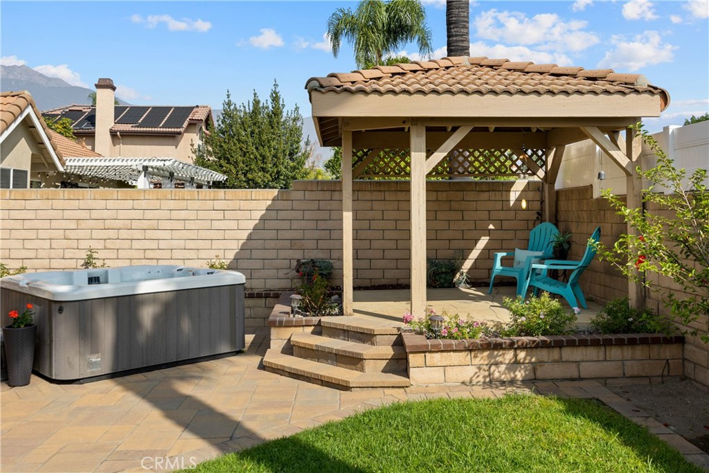 7051 Stanislaus Place Rancho Cucamonga, CA 91701 - Photo 42 of 57 a view of a patio with table and chairs with wooden floor and fence