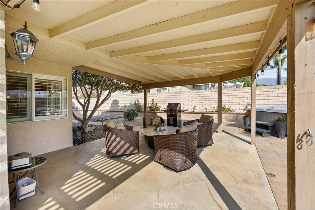 7051 Stanislaus Place Rancho Cucamonga, CA 91701 - Photo 46 of 57 a view of a patio with dining table and chairs with wooden floor