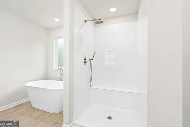 a bathroom with a bathtub and shower