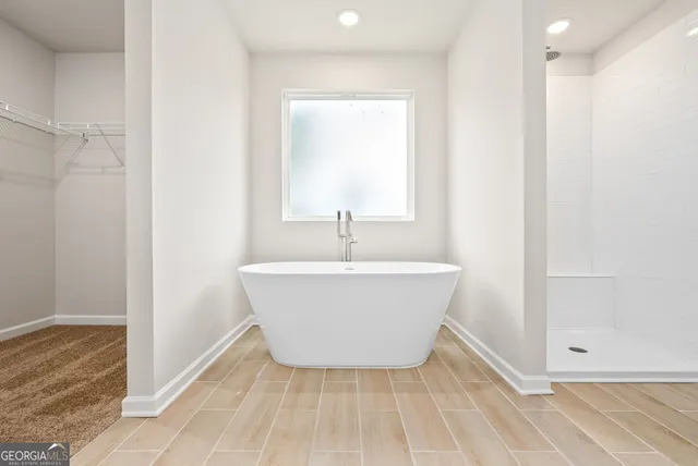 a white bath tub sitting in a bathroom