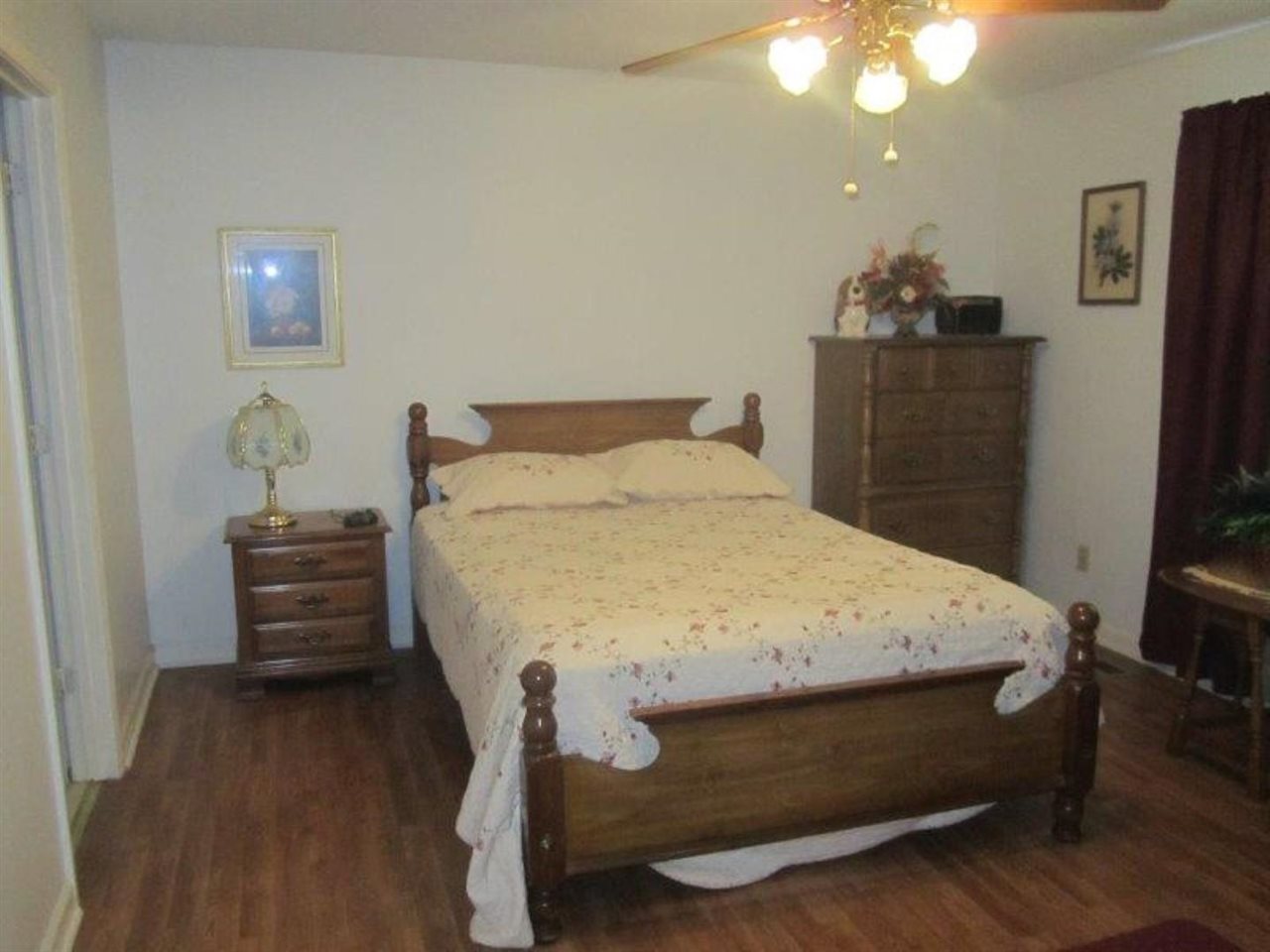 1741 Conner Whitefield Road Ripley, TN 38063 - Photo 23 of 24 a bed sitting in a bedroom and wooden floor