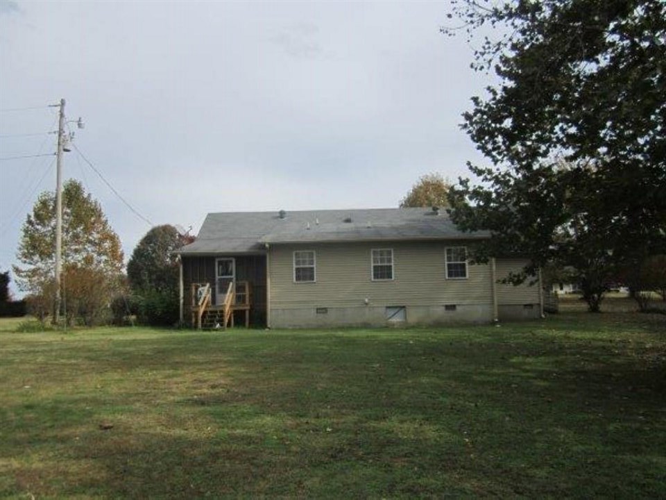 1741 Conner Whitefield Road Ripley, TN 38063 - Photo 5 of 24 a front view of a house with a yard