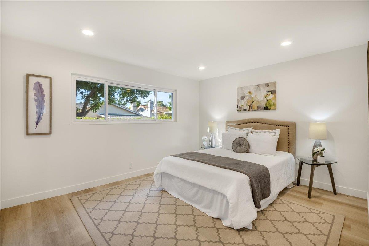 1069 Malott Drive San Jose, CA 95121 - Photo 18 of 32 a bedroom with a bed and a painting on the wall