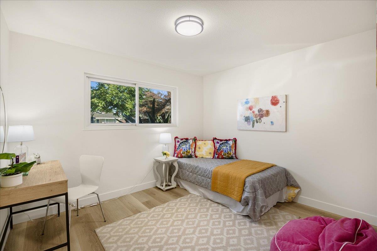 1069 Malott Drive San Jose, CA 95121 - Photo 22 of 32 a bedroom with a bed and a table in it