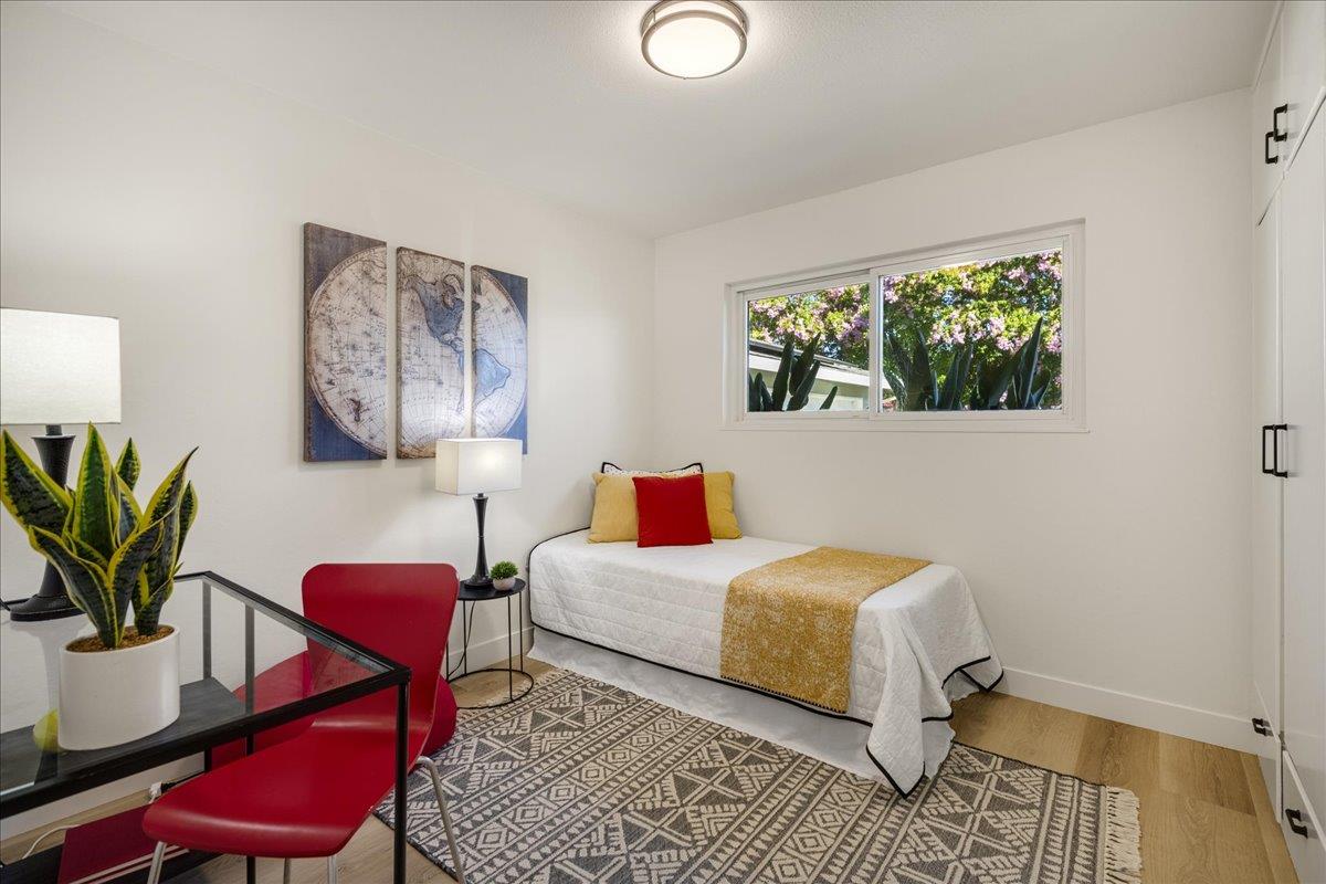 1069 Malott Drive San Jose, CA 95121 - Photo 24 of 32 a bedroom with a bed wooden floor and a lamp