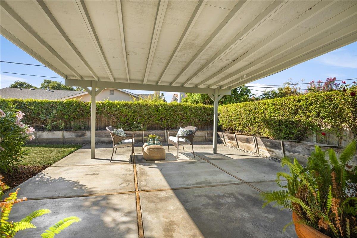 1069 Malott Drive San Jose, CA 95121 - Photo 26 of 32 a view of a patio with a table and chairs under an umbrella
