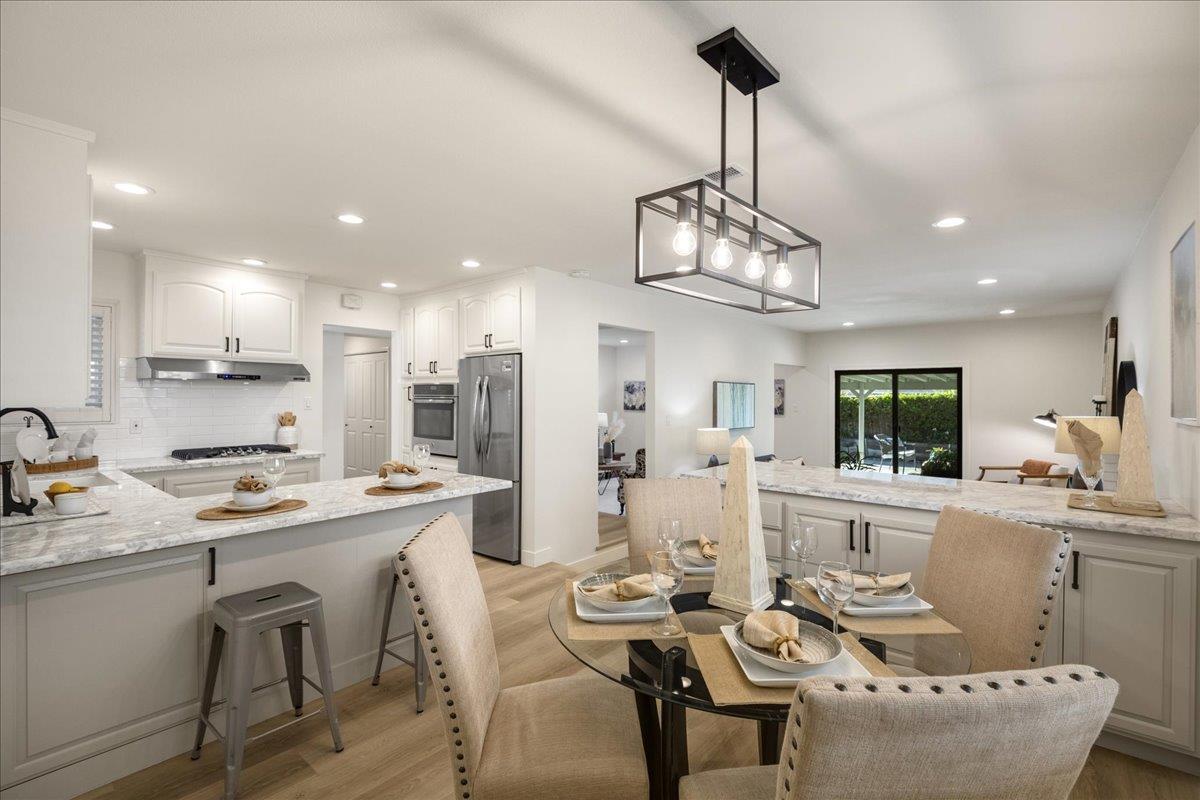 1069 Malott Drive San Jose, CA 95121 - Photo 3 of 32 a view of a dining room and livingroom with furniture wooden floor a chandelier